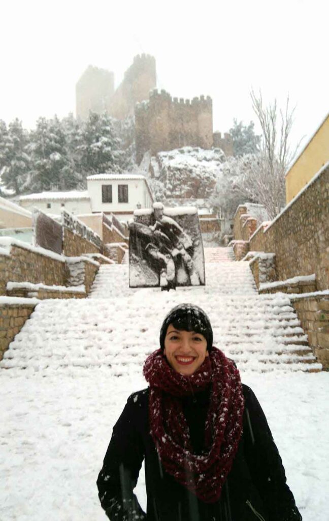 Castle of Almansa and sculpture by Jose Luis Sanchez covered in snow