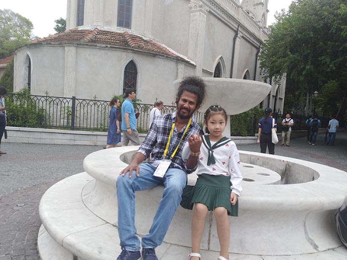 Upal with a little girl in a park in China
