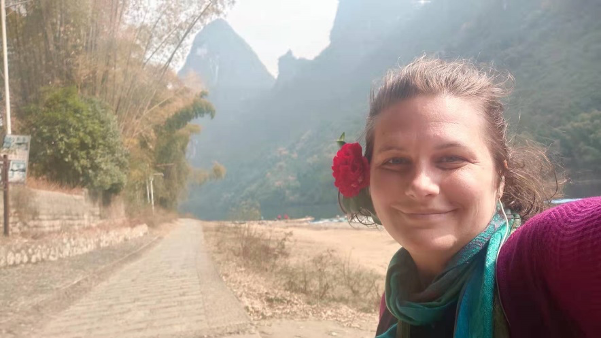 A selfie of Katherine posing with a flower in her hair in Xingping, Guilin. 