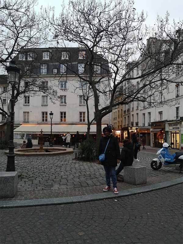 Mino is pictured standing on a street in France. 