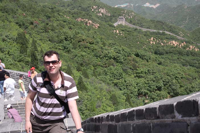 Andre on a visit to the Great Wall of China on a sunny day